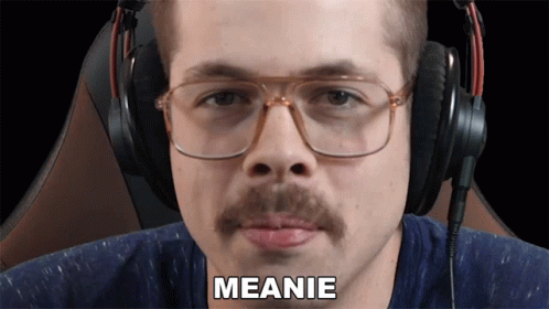 man wearing ear muffs and headphones with the word meanie in front