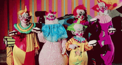 a group of clowns standing around each other