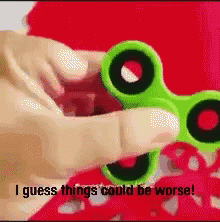 someone holding green scissors with words on them