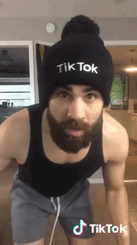 a man with fake hair and beard wearing a knit hat