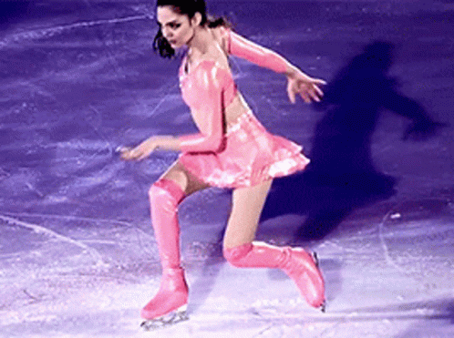 a female figure skating at a skating rink