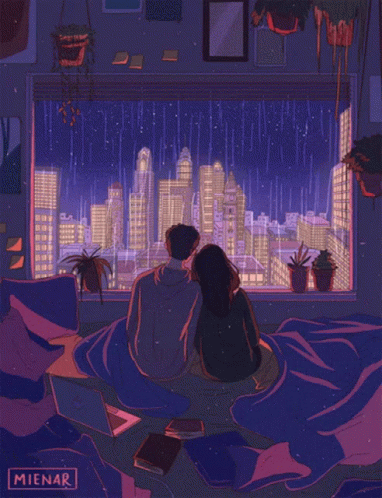 a couple looking out the window at a large city
