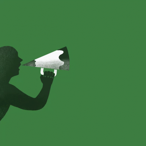 a person holding a speaker up to a green background