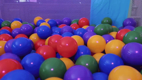 brightly colored balloons in a large ball pit