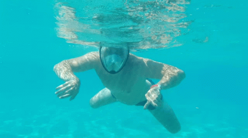 a man with a yellow shirt and white body suit under water