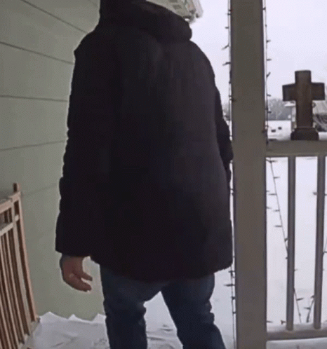man walking out in the snow wearing brown boots