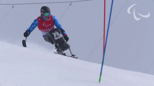 a skiier is going down the hill