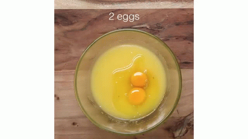 two eggs inside a glass cup on a rock surface