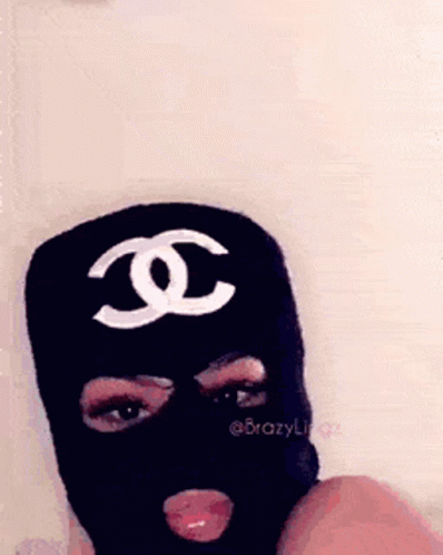 the person is wearing a black mask with the chanel logo
