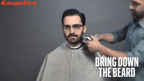 the barber has on glasses and is tying the beard