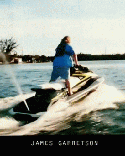 a person standing on top of a motor boat