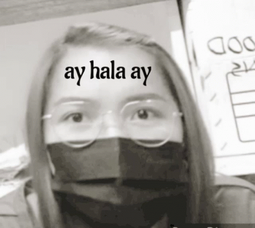 a girl with glasses, a mask and a sign that says ay hala pay