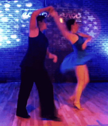 a blurry image of two people dancing