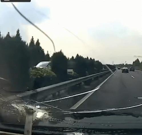 a car passing by another car on a road