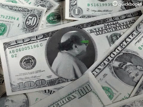 green writing on money sitting in a pile