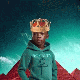 a child wearing a crown while standing in front of mountains