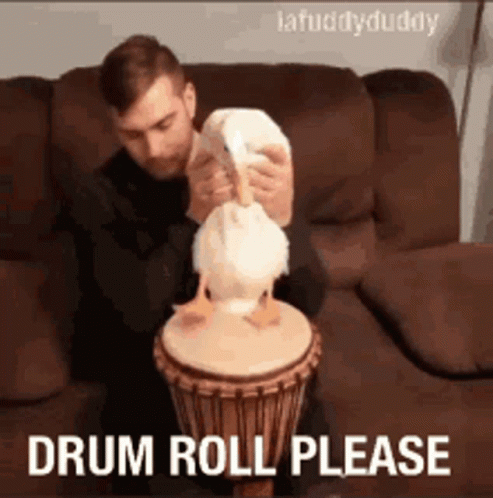 man sitting on the couch is playing with a drum
