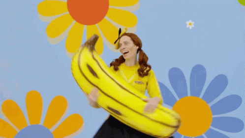 a woman with a large bunch of bananas in her hand