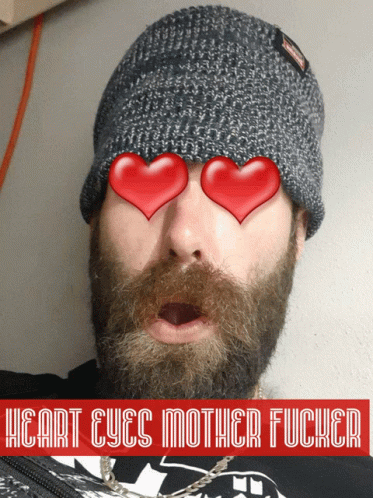 a man wearing a knit cap with hearts in it