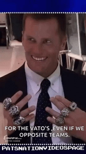 the man is holding three rings on his hands