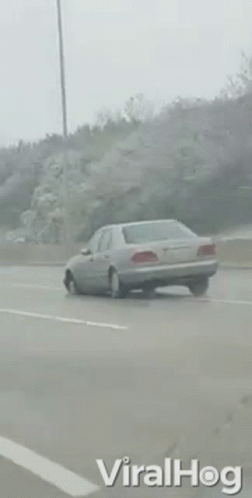 a car driving on the highway in the rain