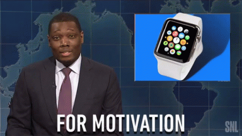 a person in a suit and tie standing next to an apple watch