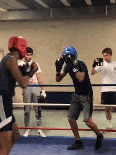 several boxing players practicing at an indoor gym