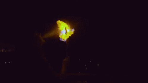 someone holding a glowing object in the dark