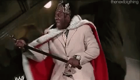 a wrestling fan dressed as a king holding two swords
