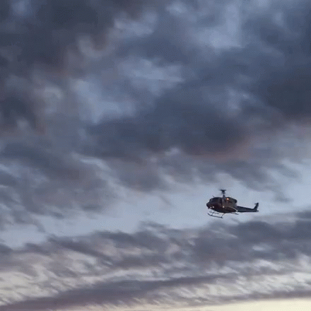 a helicopter flying in the cloudy skies