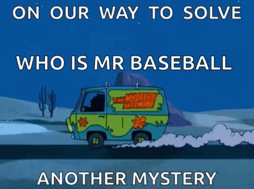 a cartoon of an ambulance with its driver blowing the dust and a quote below it reads, on our way to solve who is mr baseball