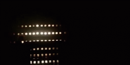 a building in the dark has some lights on it