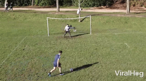a group of men play soccer in a field