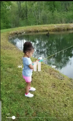 the child is by the water with his fishing rod