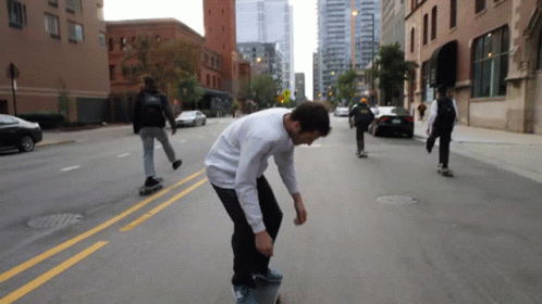 a man riding a skateboard down the middle of a street