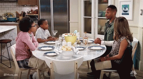 a family of five sits around the table for a dinner