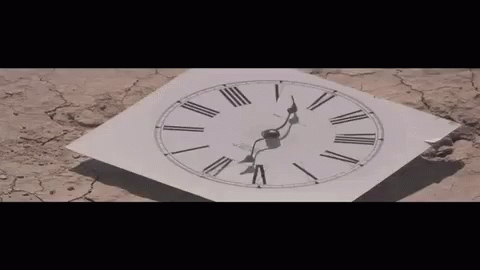 an upside down clock sitting on top of a tiled surface