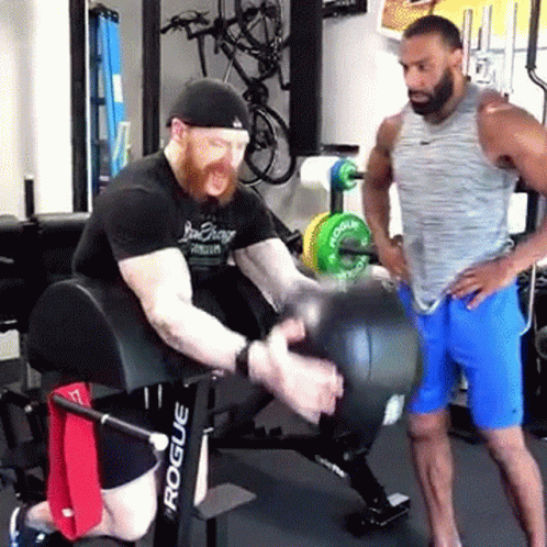 two men are working out with their body in a gym