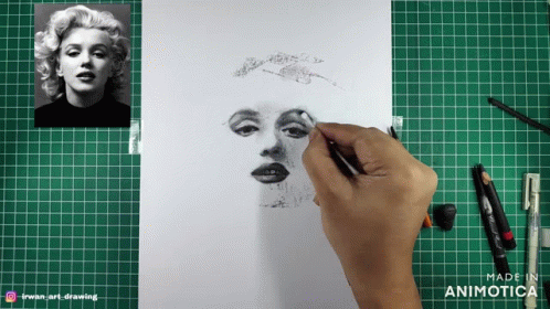 someone is making a drawing on paper with their picture