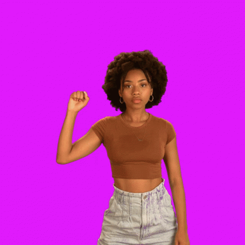 a girl is posing with a pink background