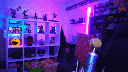 the back room with games and toys on shelves and a neon sign above them