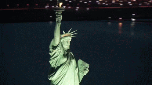 the statue of liberty, in the green light of the night