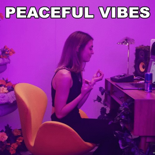 a woman sitting at a desk with the words peaceful vibes