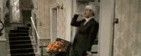 an older man in a suit walking up a stairs