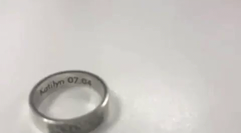 an odd shaped ring that has some writing on it
