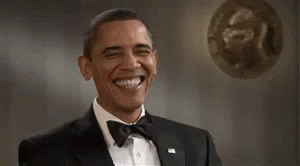 obama in a tuxedo poses for a pograph