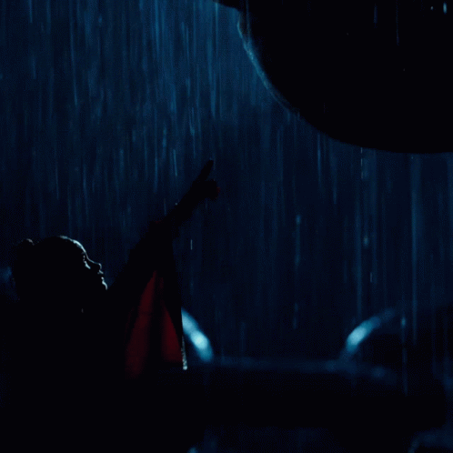 two dark men are standing in the rain