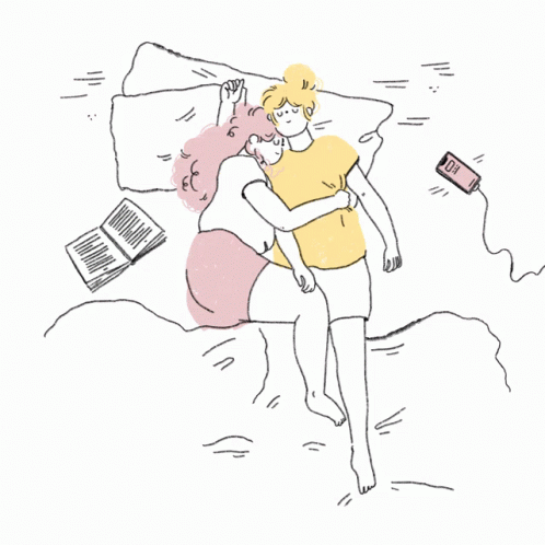 two people looking at a cellphone while they are in bed