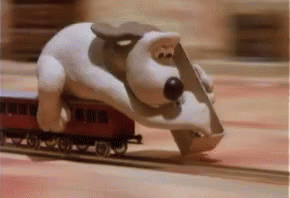 a close up of a toy train with a cartoon dog
