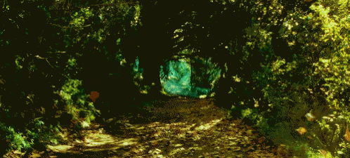 a dark tunnel with yellow lights is going through the forest
